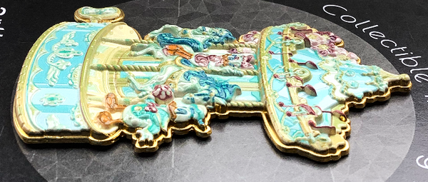 a side view of a disney pin shaped like a carousel. this side view images highlights the texture of this pin to give a 3d effect.