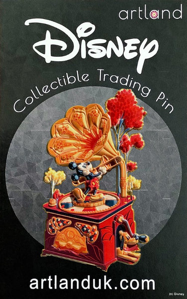  a disney pin shaped like a gramophone in reds and oranges. mickey mouse is playing the trombone in top. pluto is lying down on the ground with a cheerful expression.